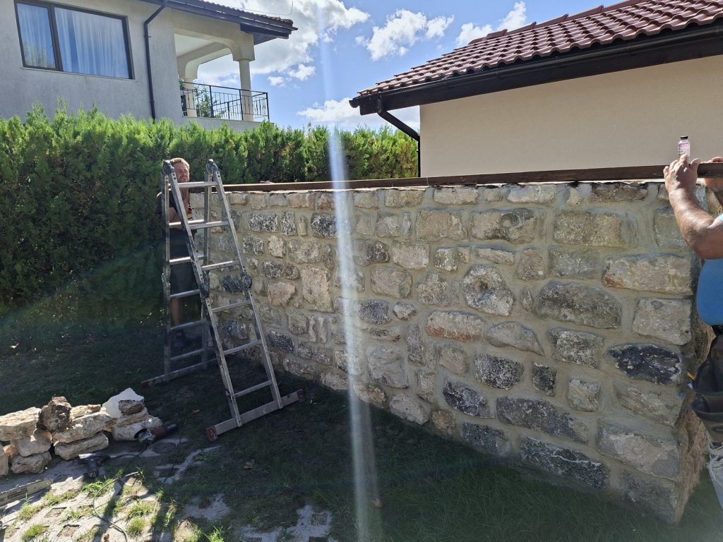 Fitting the timber structure on top of the stone wall